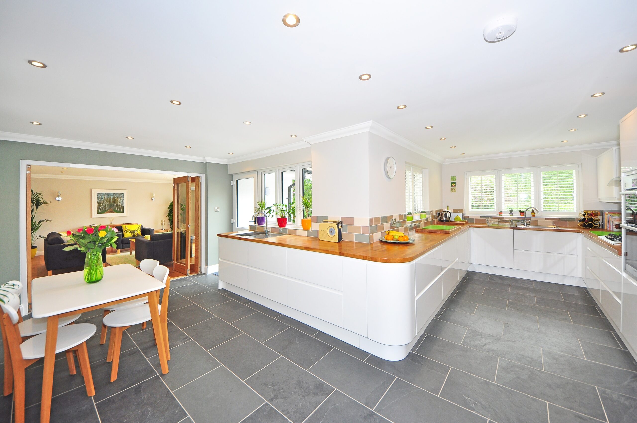 A kitchen with a dining table and chairs that offers important Concierge Services.